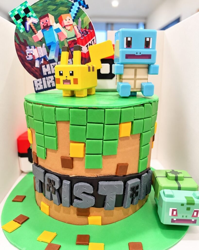 Minecraft-style birthday cake with green and brown fondant blocks, topped with blocky Pikachu and Squirtle figures